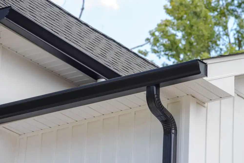 Modern black gutter system installed on residential home in Talbot County, Maryland, showcasing sleek design and professional craftsmanship