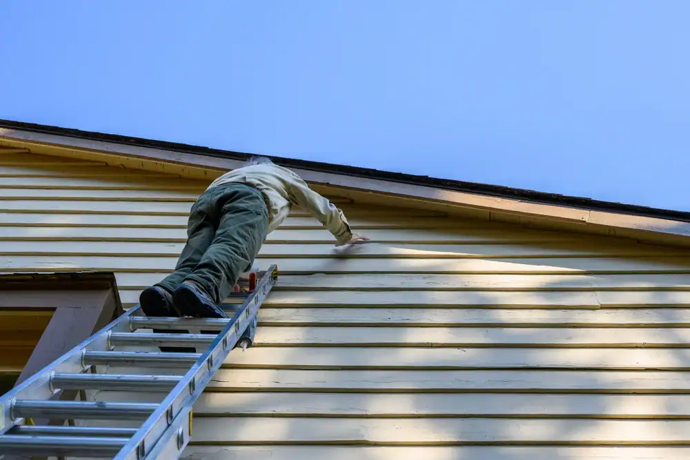 Exterior house painting in Talbot County, Maryland, with professional crew using ladder to reach upper siding, showcasing Bay Area Exteriors’ quality craftsmanship