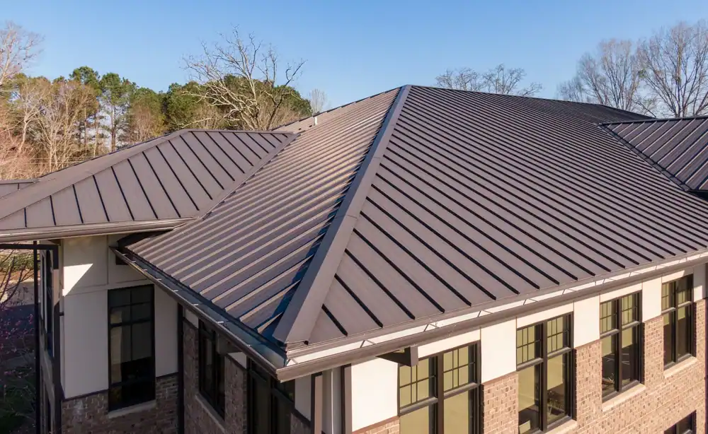 Worker expertly fits a modern metal roof on a home in Talbot County, MD, ensuring a perfect finish and long-lasting protection with Bay Area Exteriors' professional roofing services