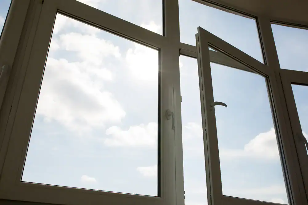 Open window revealing a cloudy sky over Talbot County, Maryland, highlighting natural light and exterior view for Bay Area Exteriors