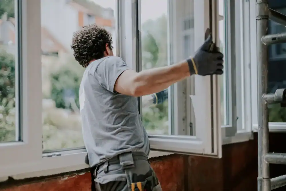 A professional Bay Area Exteriors installer securing a new energy-efficient window on a Talbot County, Maryland home, ensuring a precise fit and superior insulation for long-lasting performance